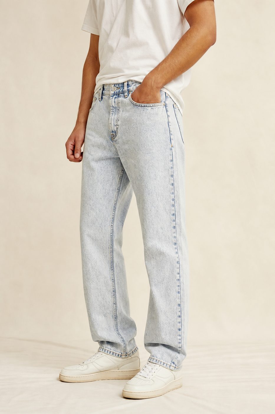 Man wearing light acid wash jeans